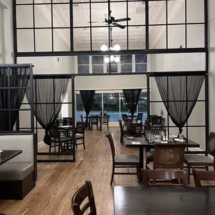 a dining room with a view of the pool