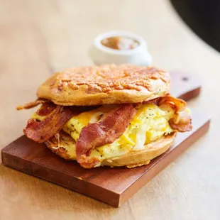 Bacon Bagel Sandwich with a side of salsa.