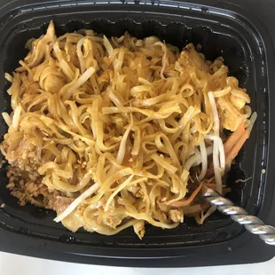 noodles and meat in a black container