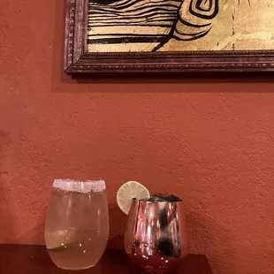 a glass of lemonade and a pitcher of lemonade