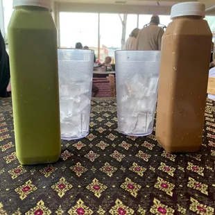 A bottle of Thai tea and a bottle of Thai coffee.