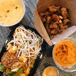 two takeout containers of food and a bowl of soup