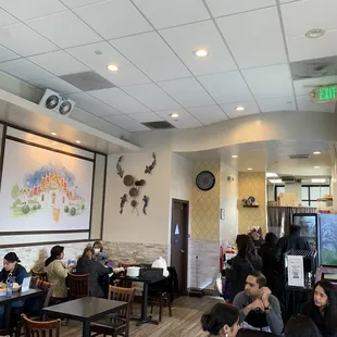 people sitting at tables in a restaurant