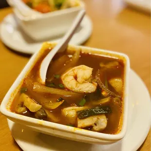 Tom Yum Goong Soup in front w/Shrimp, "King of The Sea Soup" in back. One has shrimp/one has mixed seafood. Both Excellent.
