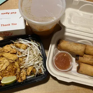 a takeout box with a variety of food items