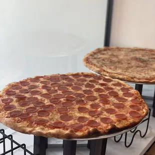 two pepperoni pizzas on display