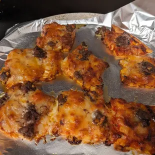 Leftover pizza, a bit overcooked, but bleeding oil everywhere.