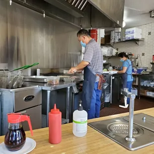 a man and a woman in a kitchen