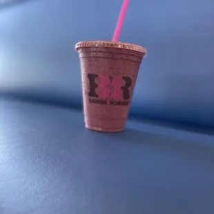 a pink drink with a straw