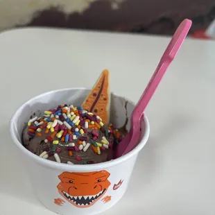 a cup of ice cream with chocolate and sprinkles