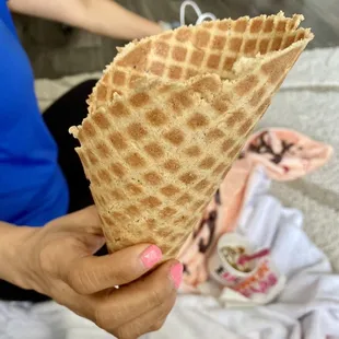 a woman holding a waffle