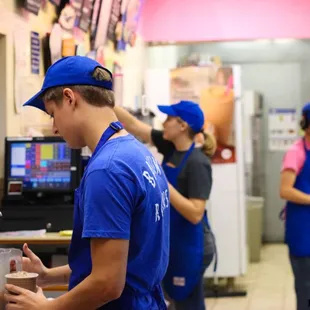 a man in a blue shirt and blue hat