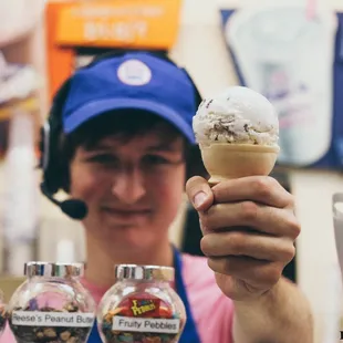 a woman holding an ice cream cone