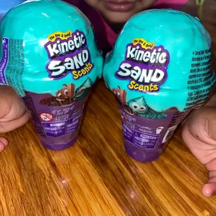 a little girl holding two kind of kind of kind of kind of kind of kind of kind of kind of kind