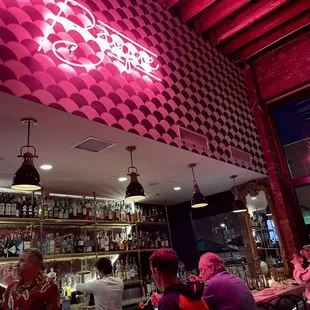 people sitting at a bar in a restaurant