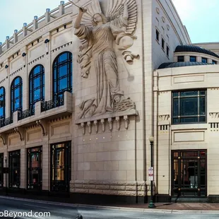 a statue of an angel on the side of the building