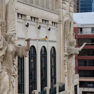 angel statues on the side of a building