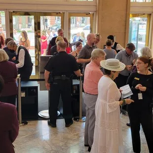 a large group of people standing and talking