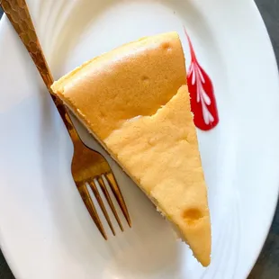 a piece of cheesecake on a plate with a fork