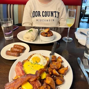 a person sitting at a table with a plate of food