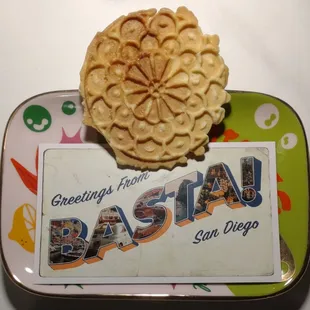 Italian waffle cookie (pizzelle) and a postcard