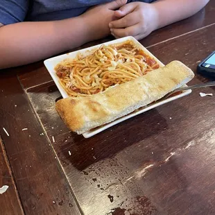 Spaghetti with a bread stick