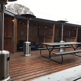 a patio with tables and umbrellas