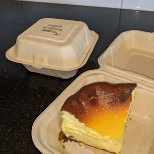 a piece of cheesecake in a styrofoam container