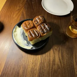 Fermented potato bread with salted butter and Old Fashioned cocktail on the right