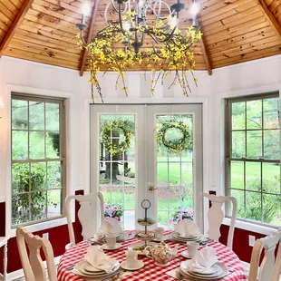 a dining room with a red and white checkered table cloth