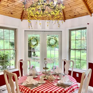 a dining room with a red and white checkered table cloth