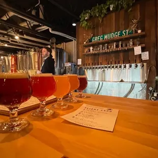 three glasses of beer on a bar