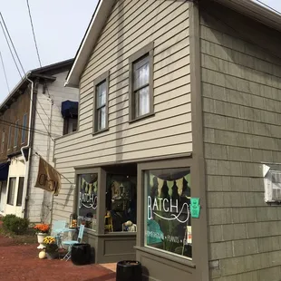 the front of a store on a brick sidewalk