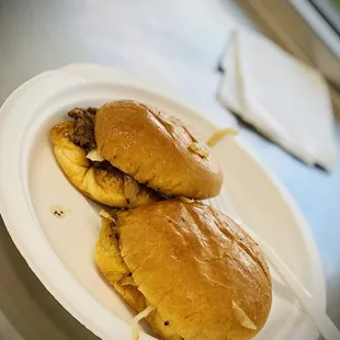 two sandwiches on a paper plate