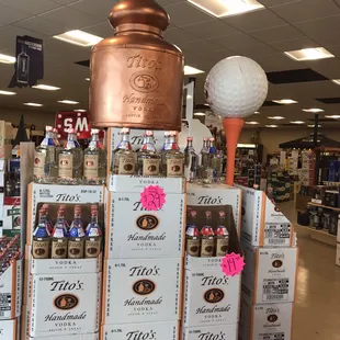 a display of bottles and a golf ball