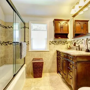 a bathroom with a sink, toilet, and shower