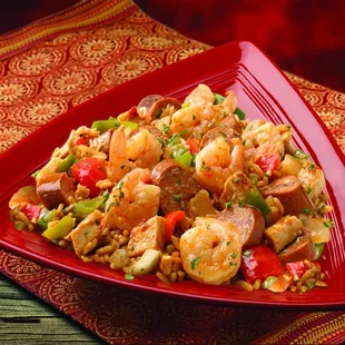 a plate of shrimp and sausage stir fry