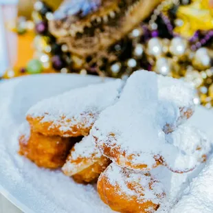 a plate of powdered sugared pastries