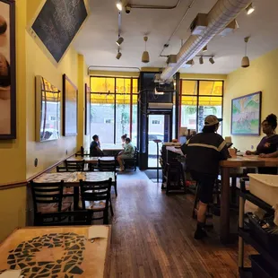 people sitting at tables in a restaurant