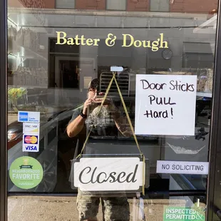 a man holding a closed sign