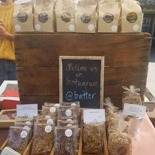 a woman standing in front of a display of baked goods