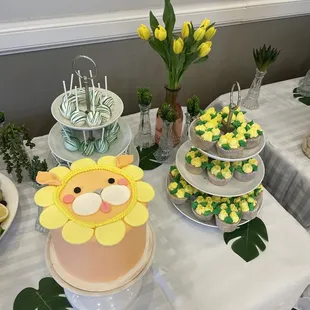 a table with a cake and cupcakes