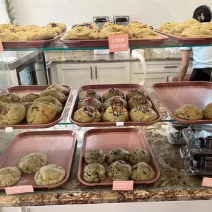 a variety of cookies on display in a bakery