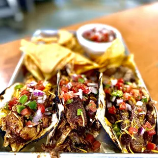 a tray of tacos and chips
