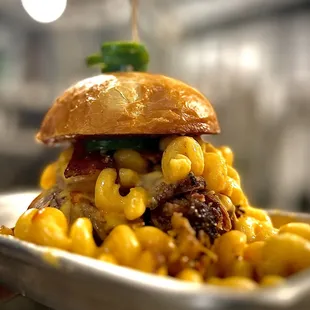a burger with macaroni and cheese