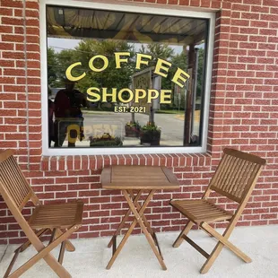 two chairs and a table in front of a window