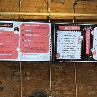 a menu on a brick wall
