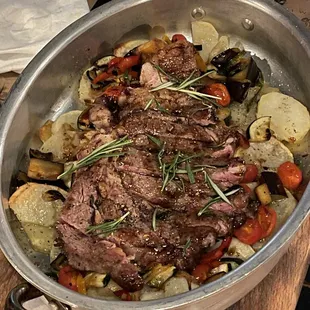 a steak and vegetables in a pan