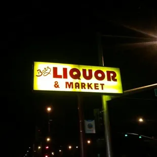 a neon sign for a liquor and market