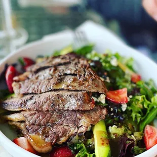 The Rio steak salad.Grilled tender steak over mixed greens, juicy strawberries, avocados, gorgonzola cheese, tossed in Caribbean Vinaigrette